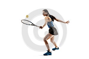 Full length portrait of young woman playing tennis isolated on white background