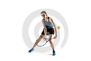 Full length portrait of young woman playing tennis isolated on white background