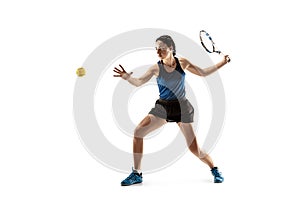 Full length portrait of young woman playing tennis isolated on white background