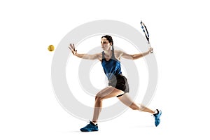 Full length portrait of young woman playing tennis isolated on white background