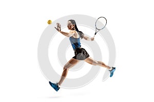 Full length portrait of young woman playing tennis isolated on white background