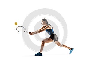 Full length portrait of young woman playing tennis isolated on white background