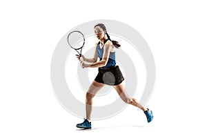 Full length portrait of young woman playing tennis isolated on white background