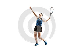 Full length portrait of young woman playing tennis isolated on white background