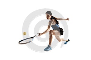 Full length portrait of young woman playing tennis isolated on white background