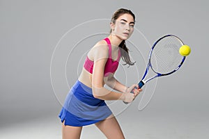 Full length portrait of young woman playing tennis isolated on white background. Healthy lifestyle. The practicing, fitness, sport