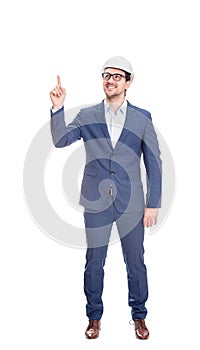 Full length positive engineer wearing protective helmet, confident pointing up his forefinger isolated on white background