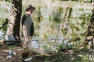 Full length of a professional angler holding equipment