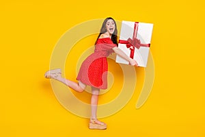 Full length profile photo of excited cheerful person hands hold heavy big giftbox isolated on yellow color background