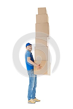 Full length profile portrait of courier carrying stack of boxes