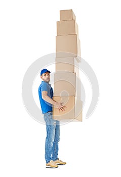 Full length profile portrait of courier carrying stack of boxes