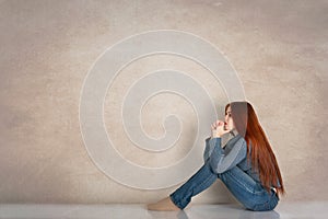 Full length profile portrait of a young woman wearing blue swea