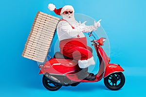 Full length profile side photo of crazy white grey hair bearded santa claus drive x-mas christmas scooter deliver pizza