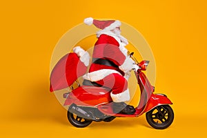 Full length profile side photo of santa claus with beard ride drive motorbike fast deliver x-mas christmas sack bag