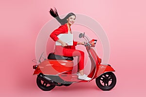 Full length profile side photo of young girl happy smile hold laptop ride bike meeting isolated over pink color