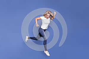Full length profile side photo of young woman happy amazed shocked go walk jump look empty space isolated over blue