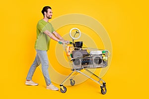 Full length profile side photo of youth guy store mall discount customer isolated over yellow color background