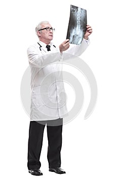 full-length. qualified mature doctor looking at the x-ray.