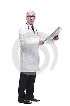 full-length. qualified mature doctor looking at the x-ray.