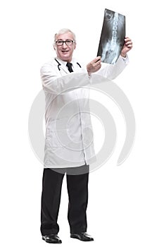 full-length. qualified mature doctor looking at the x-ray.