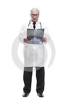 full-length. qualified mature doctor looking at the x-ray.