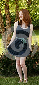 Full length redhead girl in dress