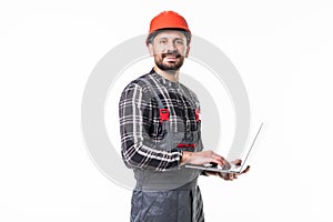 Repairman in hemlet using laptop against white background