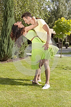 Full length of romantic young couple dancing in park