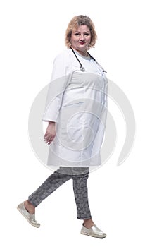 full-length. senior female doctor confidently striding forward.