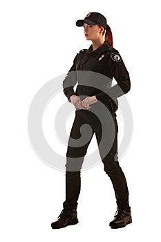 Full length shot of a redheaded female police officer posing for the camera isolated on white background.