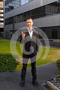 Full length shot of businessman standing outdoors wearing suit