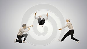 Three guys in white shirts dancing in synch looking at camera on gradient background.