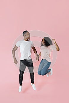 Full length shot of jumping african couple having fun together.