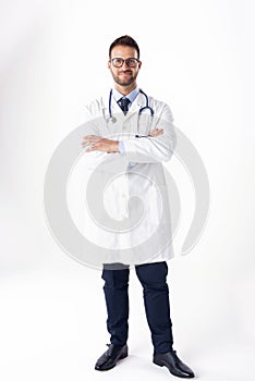 Full length shot of male doctor standing at isolated white background