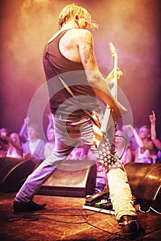 Full length shot of a musician playing guitar for a crowd at a gig. This concert was created for the sole purpose of