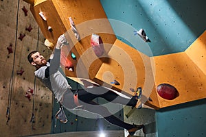 Full length shot of physically impaired mountaineer practicing rock climbing