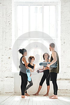 Full-length shot of positive people talking in gym