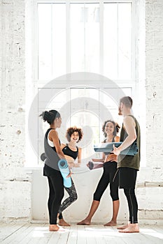 Full-length shot of positive people talking in gym