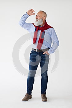 Smiling senior bearded man looking sideway, holding hands near f photo