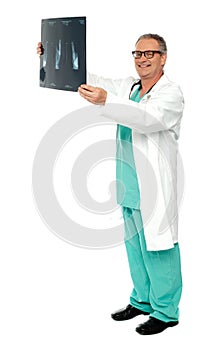 Full length shot of a surgeon with x-ray report