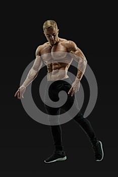 Full-length shot of young man with muscular body
