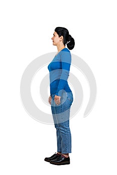 Full length side view of casual young woman standing relaxed looking ahead isolated over white background