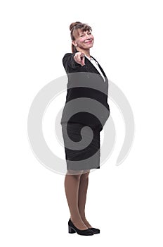 Full length, side view of a confident young business woman standing with folded hands