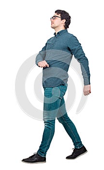 Full length side view of young businessman confident walking isolated on white background. Motion shot, person making a step going