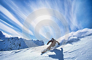 Full length of skier skiing on fresh powder snow