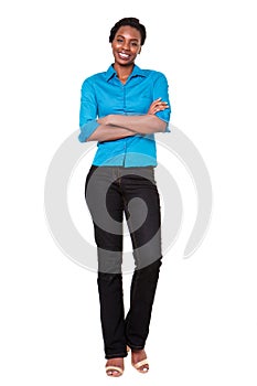 Full length smiling african american woman standing with arms crossed on white background