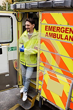 Full length of smiling paramedic standing