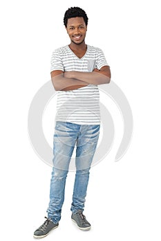 Full length of a smiling young man with arms crossed