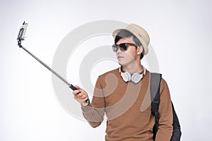 Full length of smiling young man selfie over white background