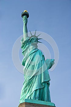 Full length Statue of Liberty against blue sky